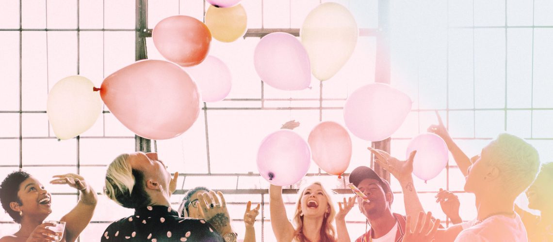 People playing with balloons at a party wallpaper